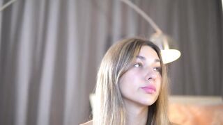 tait_less -Young woman in clothes teasing in front of the camera and sweet talking and does not want to take off her clothes