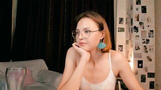 radiant_starline -A student in clothes sits talking and is embarrassed to undress on camera