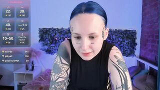 bennymurrh_ - A young woman in a dress with tattoos cutely communicates and teases in front of the camera